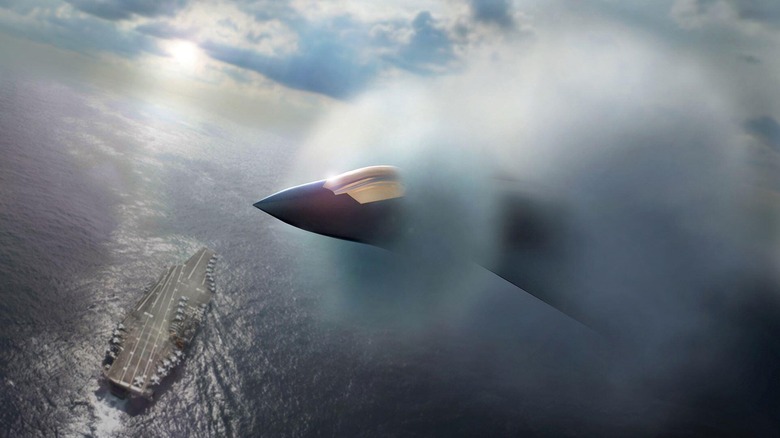 Künstlerische Darstellung einer F/A-XX im Flug, umgeben von Nebel, über einem Flugzeugträger